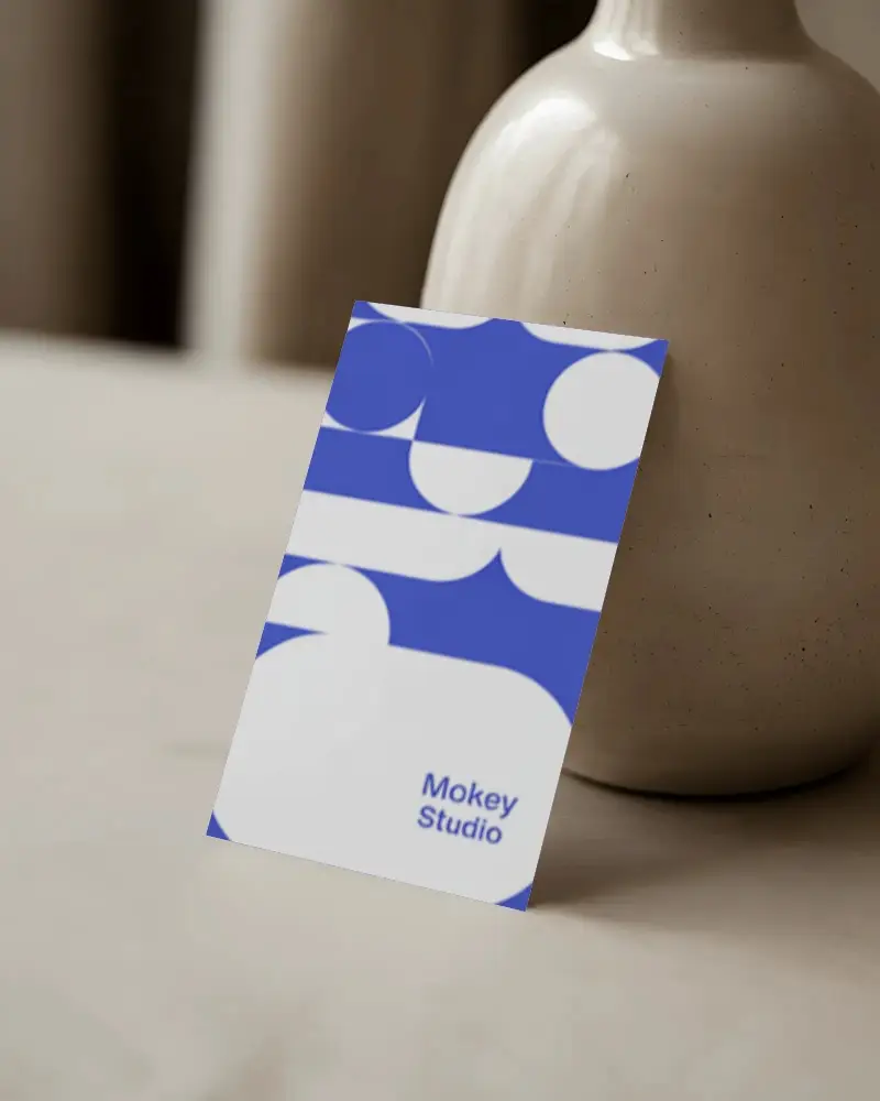 minimalist-vertical-business-card-mockup-leaning-against-ceramic-vase-elegant-styling