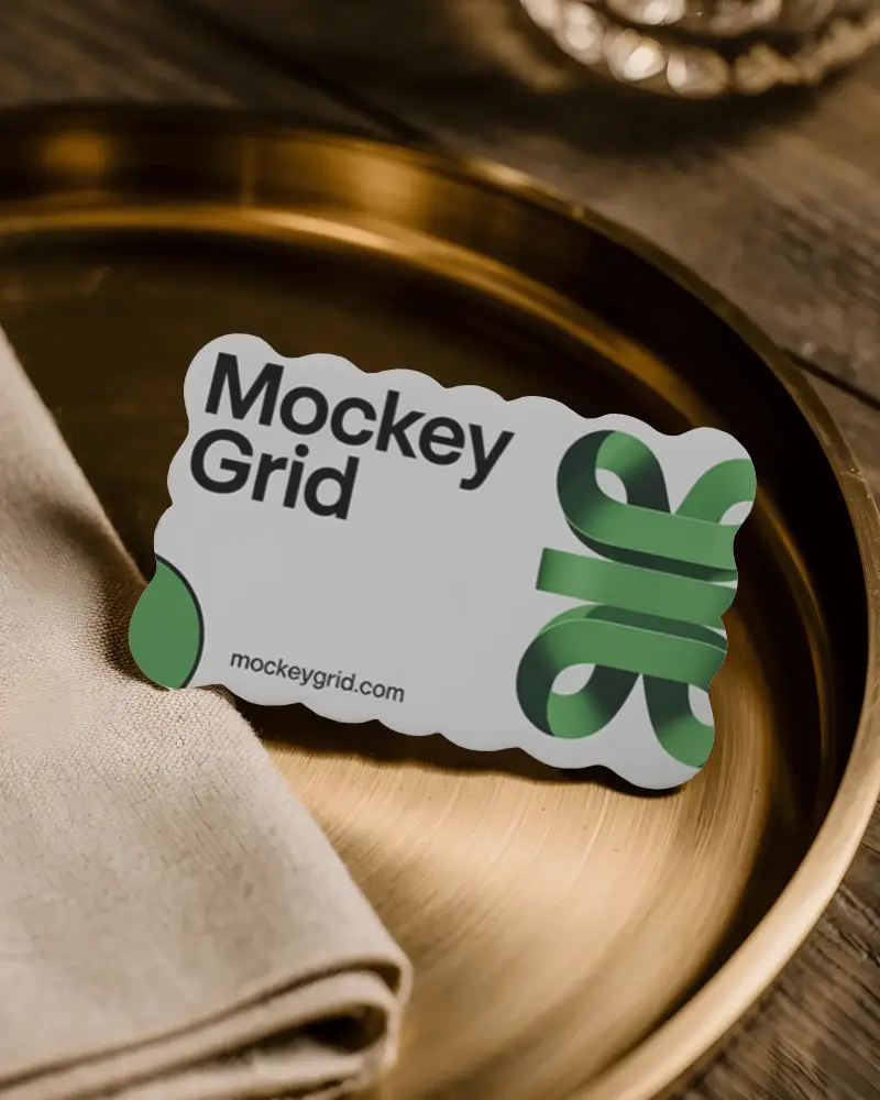 Elegant Wavy Edge Business Card Mockup On Metallic Plate With Fabric Napkin Tabling