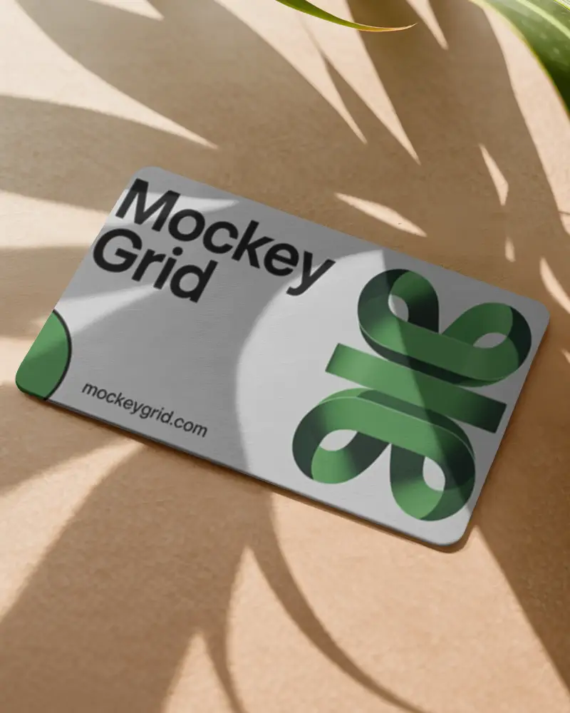 Tropical Business Card Mockup On Sandy Surface With Sunlight And Large Plant Leaf Shadows