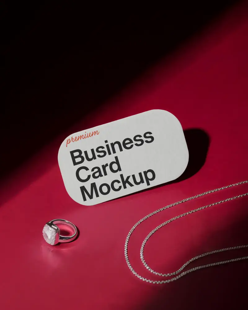 Jewelry Style Rounded Business Card Mockup On Red Surface With Silver Chain And Gemstone Ring