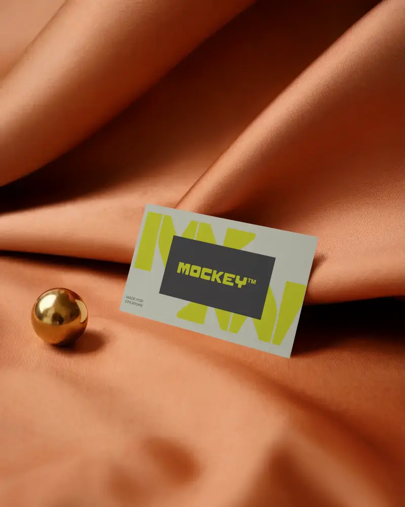 Elegant Fabric Business Card Mockup On Soft Silk Surface With Golden Sphere Decor Element