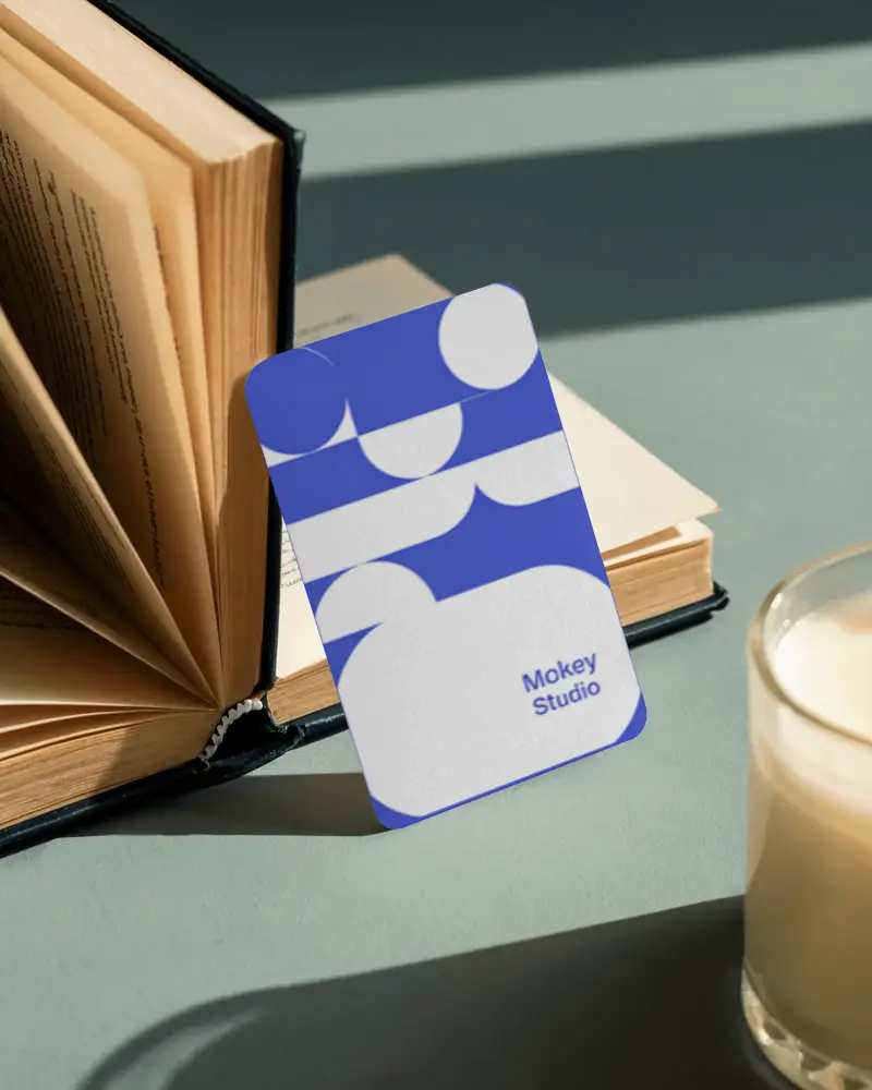 Cozy Reading Business Card Mockup Vertical Card Leaning On Open Book With Milk Glass Nearby