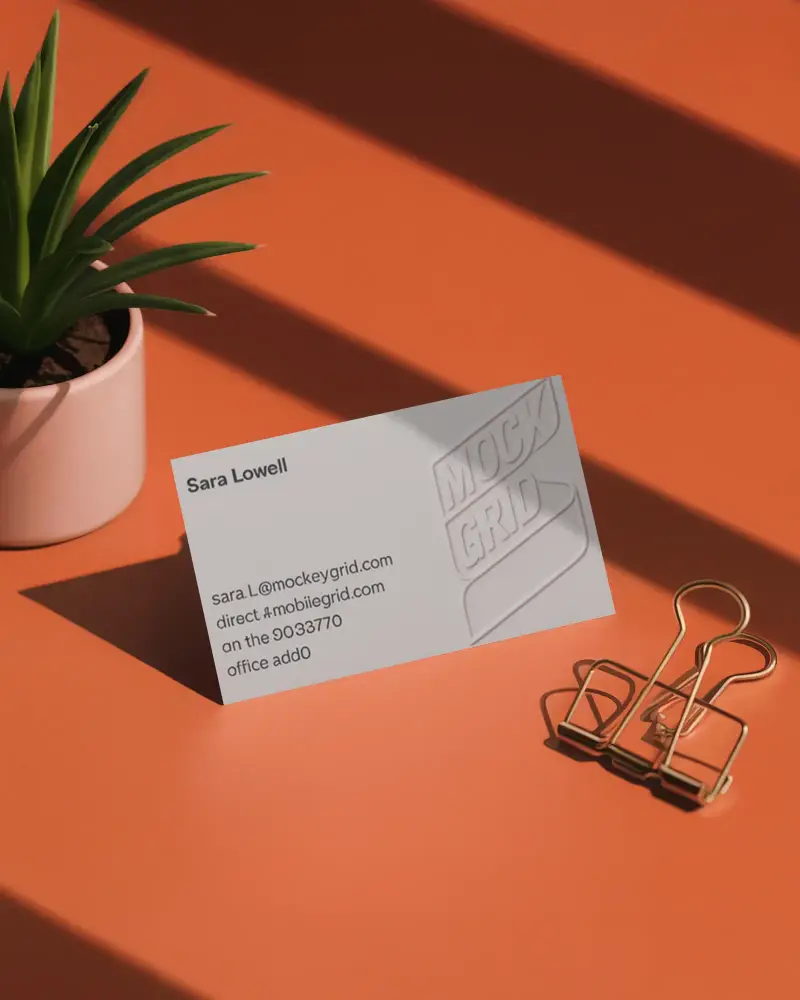Modern Desk Horizontal Business Card Mockup On Orange Surface With Plant Pot And Metal Paper Clip