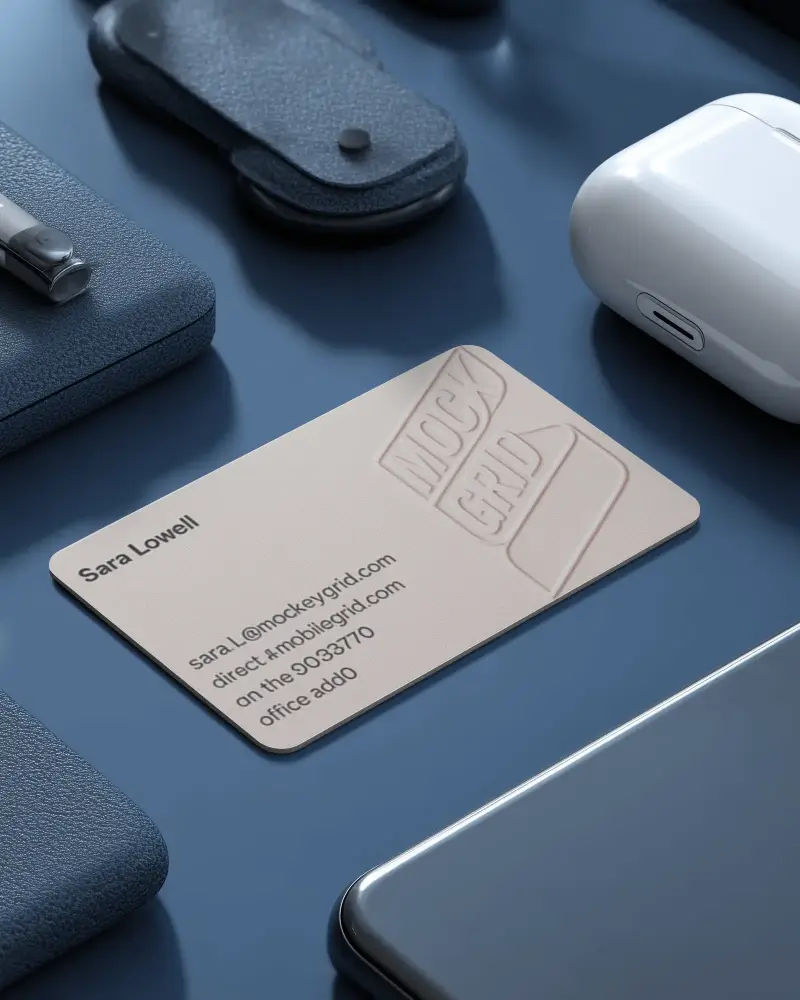 Stylish Rounded Horizontal Business Card Mockup On Blue Desk With Tech Gadgets Wallet And Airpods