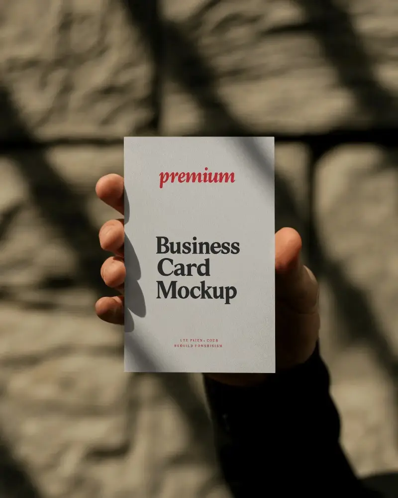 Closeup Hand Holding Vertical Business Card Mockup Natural Sunlight And Stone Texture Scene