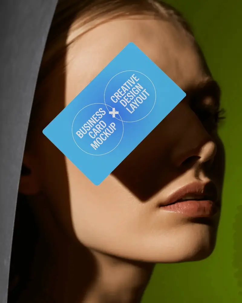 Elegant Business Card Mockup Floating Over Model Face With Dramatic Light And Shadow Effect