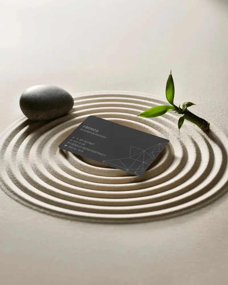 zen-garden-business-card-mockup-placed-in-sand-circles-with-stone-and-bamboo-detail