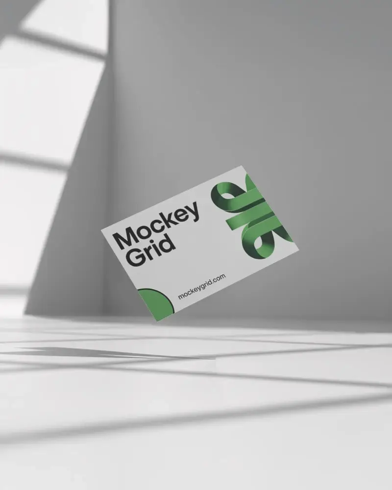 minimal-business-card-mockup-hovering-above-white-floor-with-angled-light-and-sharp-shadows