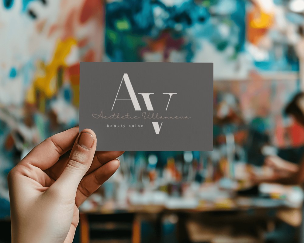 Hand Holding Business Card Mockup With Colorful Art Studio Background Creative And Artistic Vibe