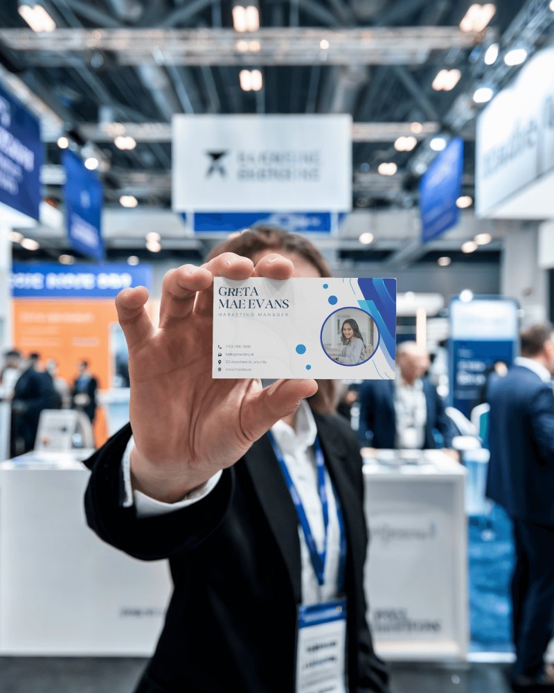 Conference Booth Business Card Mockup Hand Holding Card In Focus Blurred Background