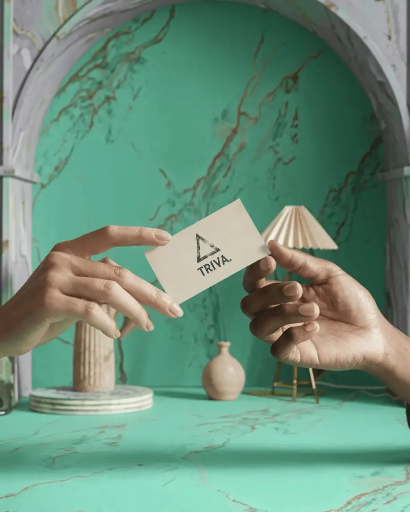 Stylized Interior Business Card Mockup Hands Exchanging Card In Modern Arched Setting With Mint Marble Backdrop 0175