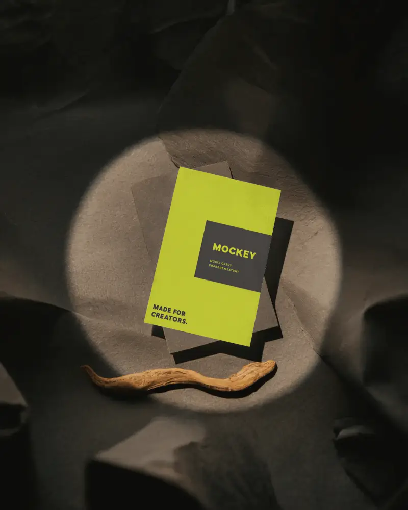 Spotlight Business Card Mockup On Dark Textured Surface With Organic Wood Element