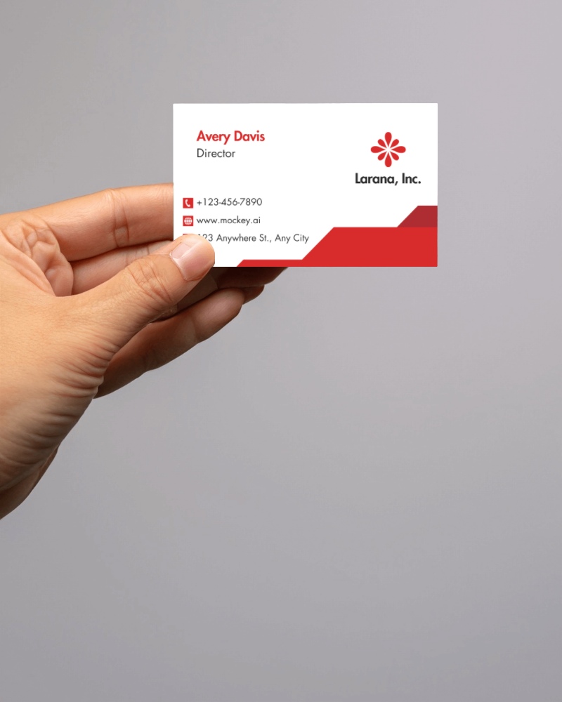 Hand Holding Business Card Mockup Against Light Gray Backdrop