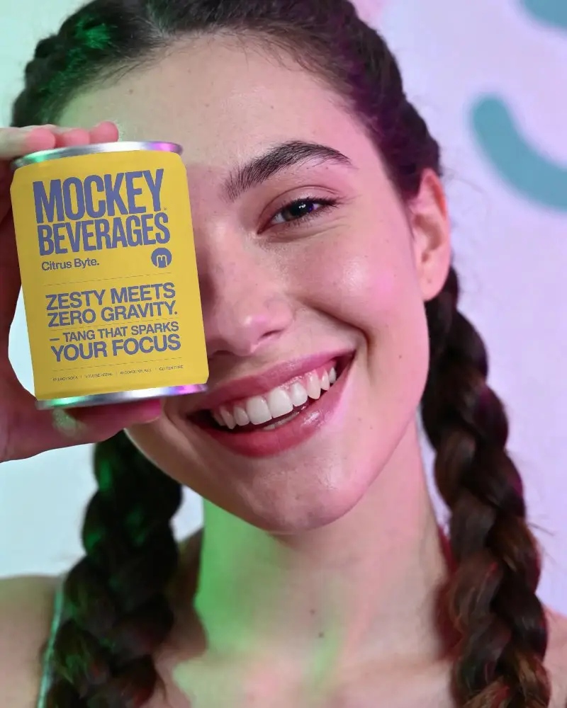 Young Woman Holding Blank Aluminum Can Mockup For Product Packaging Design