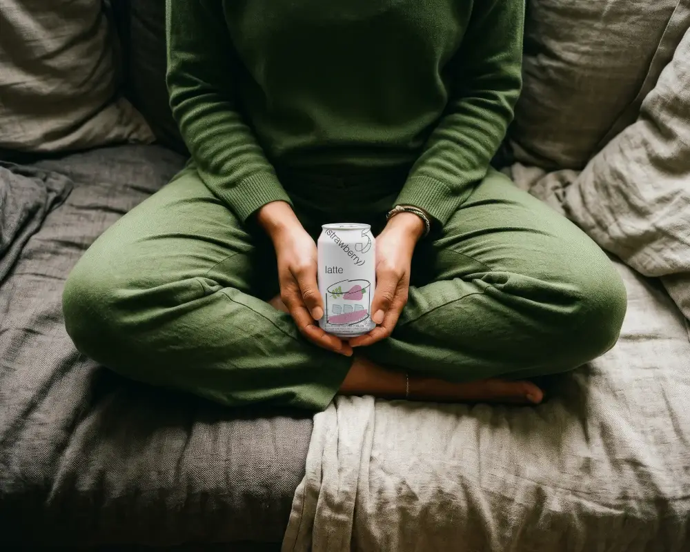 Cozy At Home Sitting On Couch With Hands Holding Empty Design Can Mockup