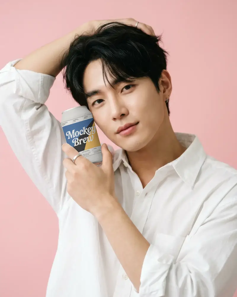 Young Man Holding Blank Drink Can Mockup Close Up Portrait Against Pink Background