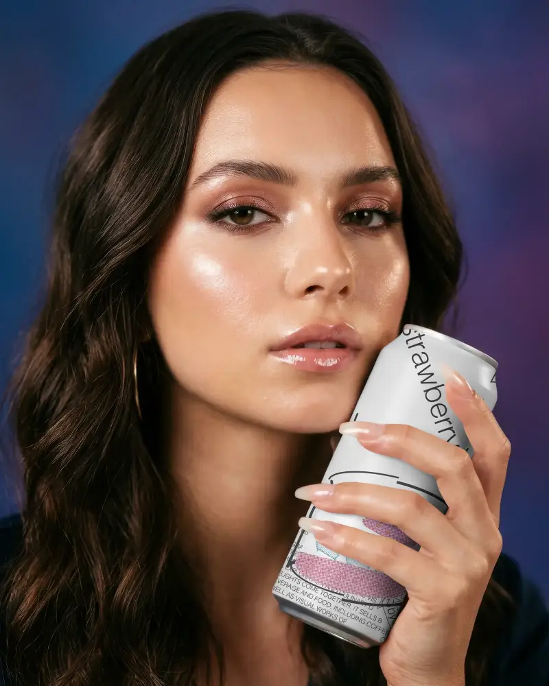 Stylish Woman Presenting Blank Metal Can Mockup For Drink Packaging And Brand Promotion