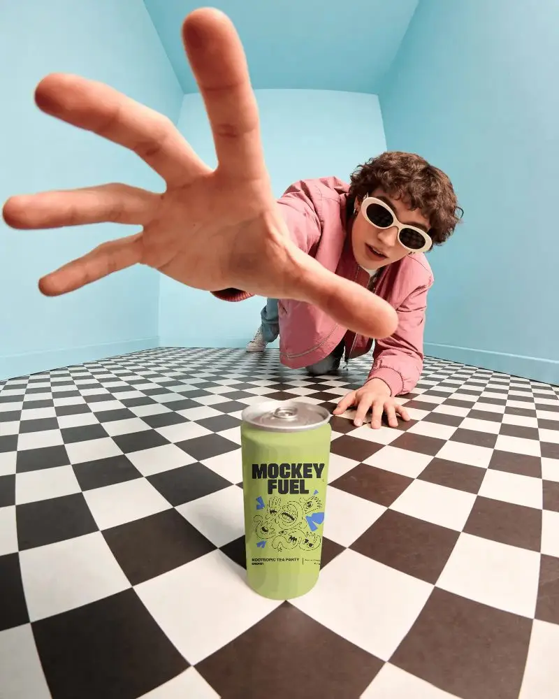 Modern Can Mockup With Person Extending Hand Over Contrasting Geometric Background