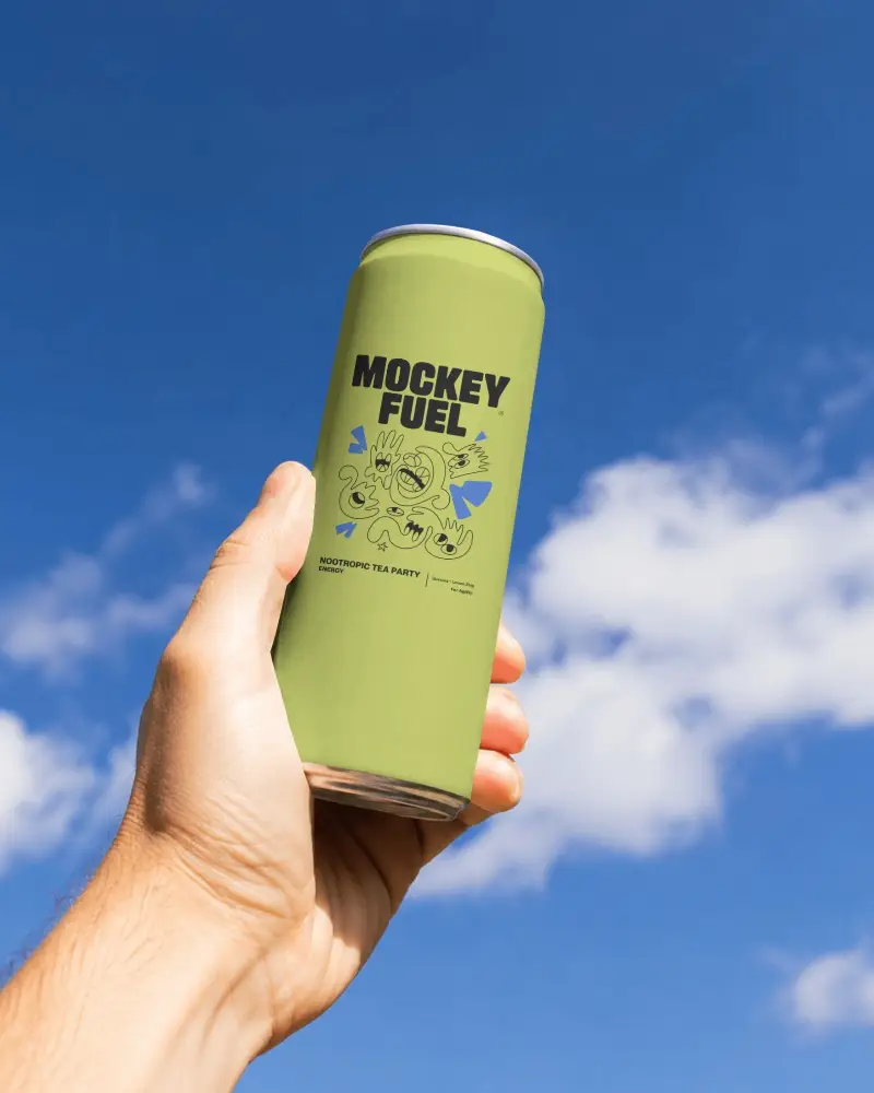 Handheld Beer Can Mockup Against Blue Sky With Soft Clouds And Clean Outdoor Branding Space