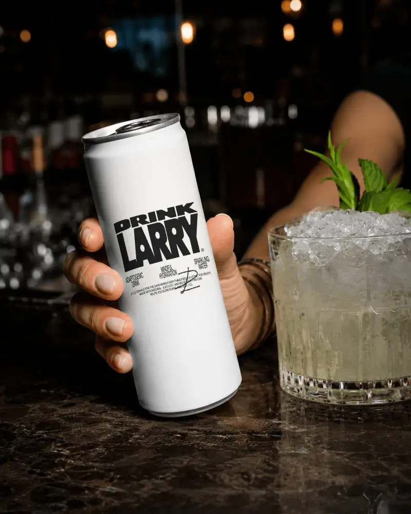 Bar Counter Soda Can Mockup Held In Hand With Cocktail Glass Ice Mint And Moody Nightlife Background