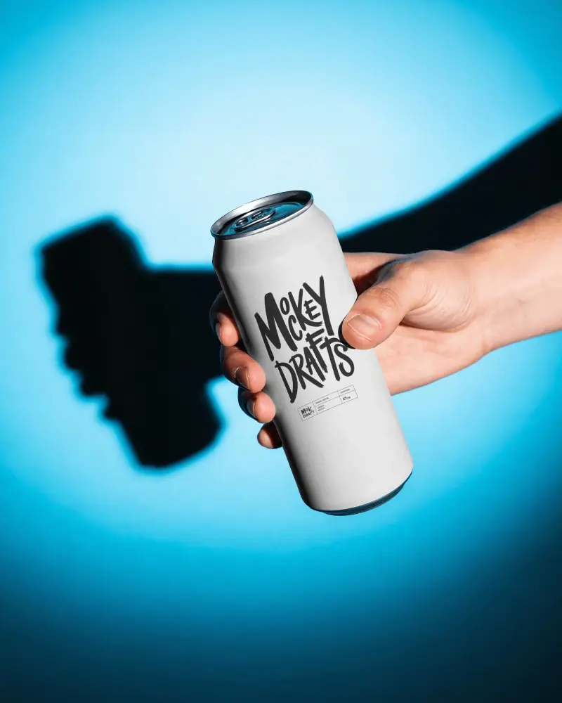 Blank Soda Can Mockup Held In Hand With Cyan Studio Backdrop Dramatic Shadow And Clean Branding