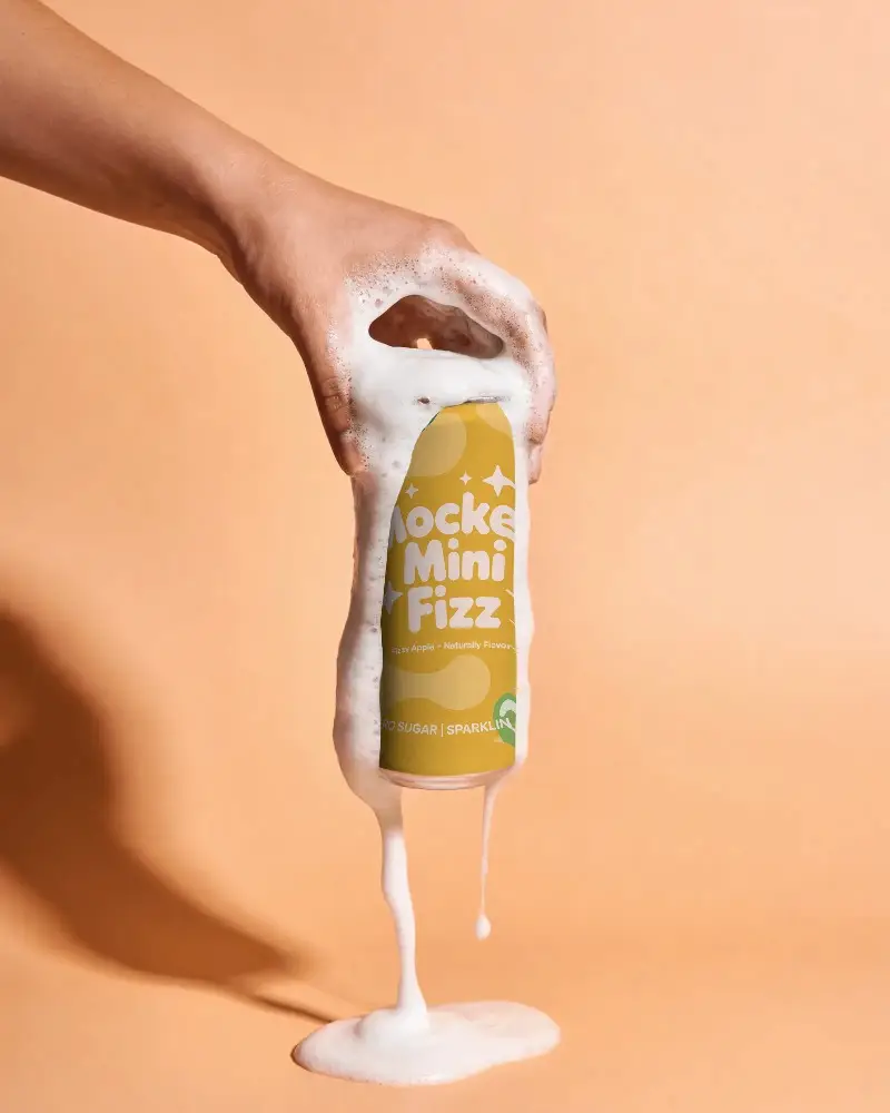Foamy Beverage Can Mockup With Hand Holding And Dripping Foam For Branding And Marketing