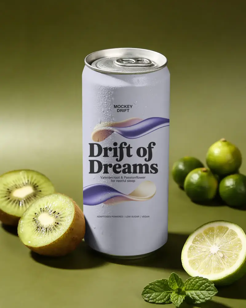 Sleek Tall Beverage Can Mockup With Condensation Next To Fresh Kiwi Citrus And Mint Leaves