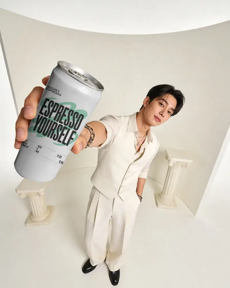 Trendy Guy Showing Sleek Drink Can Mockup Modern Minimalist Studio Portrait
