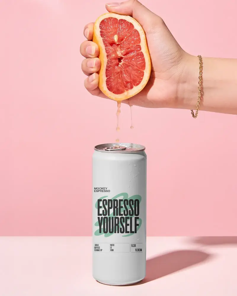 Hand Squeezing Fruit Juice Into A Tall Can Mockup On Pastel Background For Drink Design