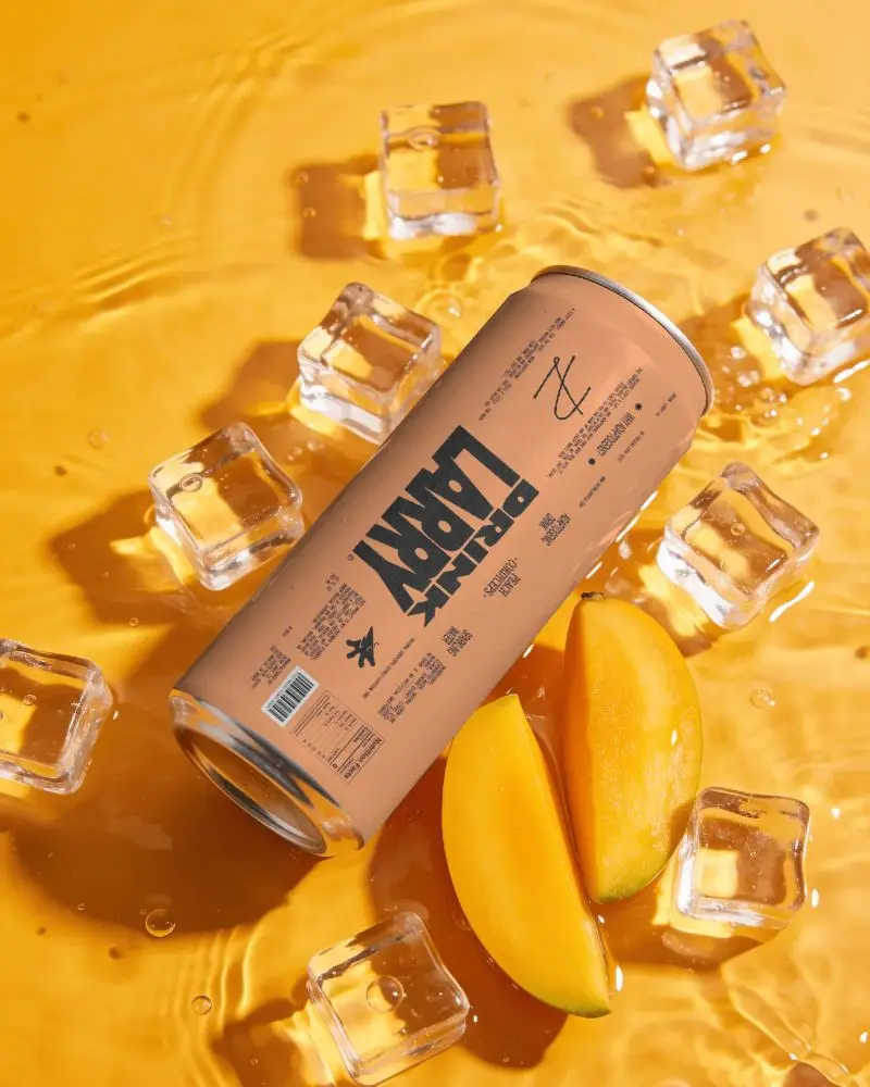 Sleek Cylindrical Beverage Can Mockup With Fresh Fruit And Ice Cubes On Liquid Surface