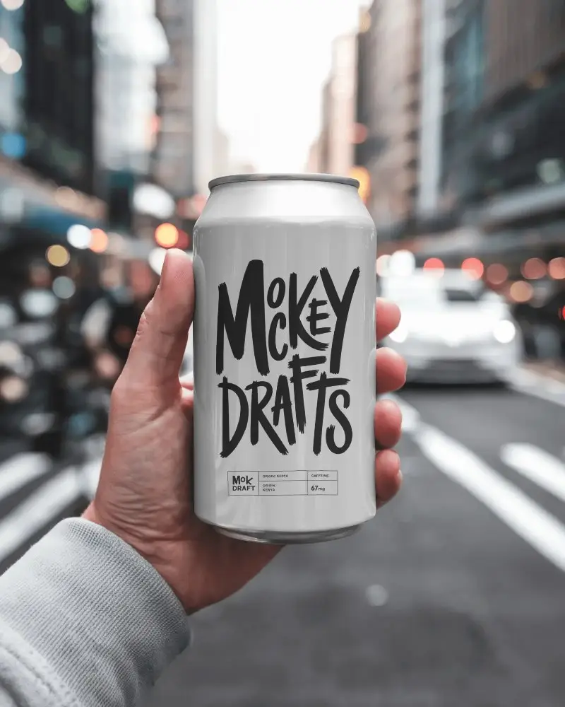 Hand Holding Can In Urban Roadside Environment With City Background For Outdoor Brand Visualization