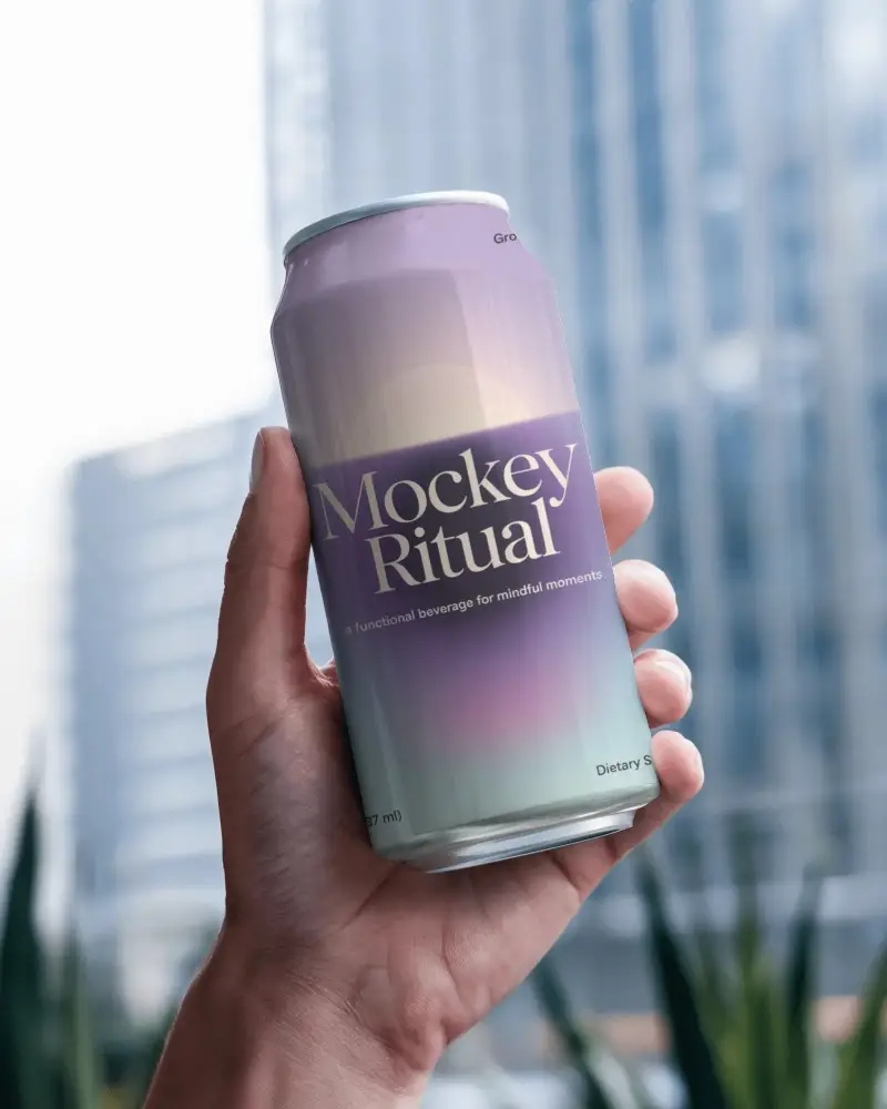 Urban Skyscraper Can Mockup Held Outdoors With Glass Reflections And Blurred Background Cityscape