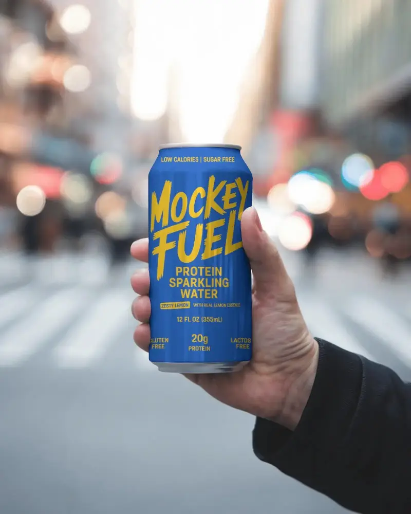 Street Scene Can Mockup Handheld With Busy Blurred Urban Crosswalk And Bokeh Night Vibe