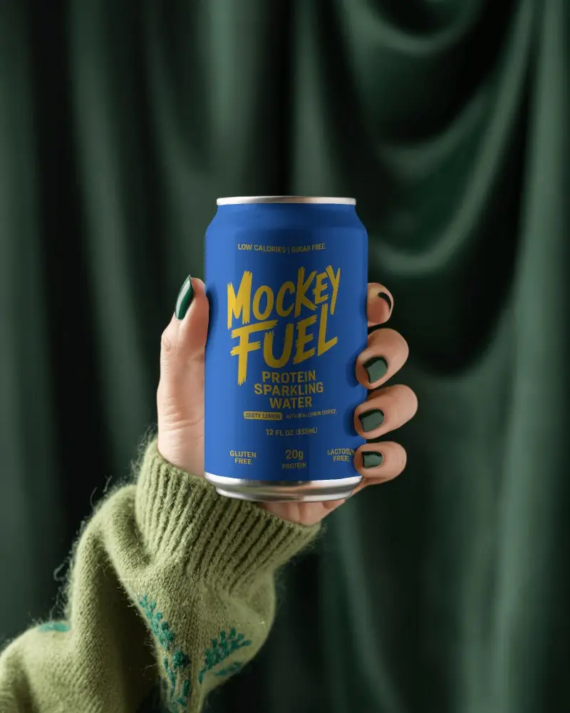 Cozy Green Can Mockup Hand In Sweater Holding Drink Against Dark Fabric Background