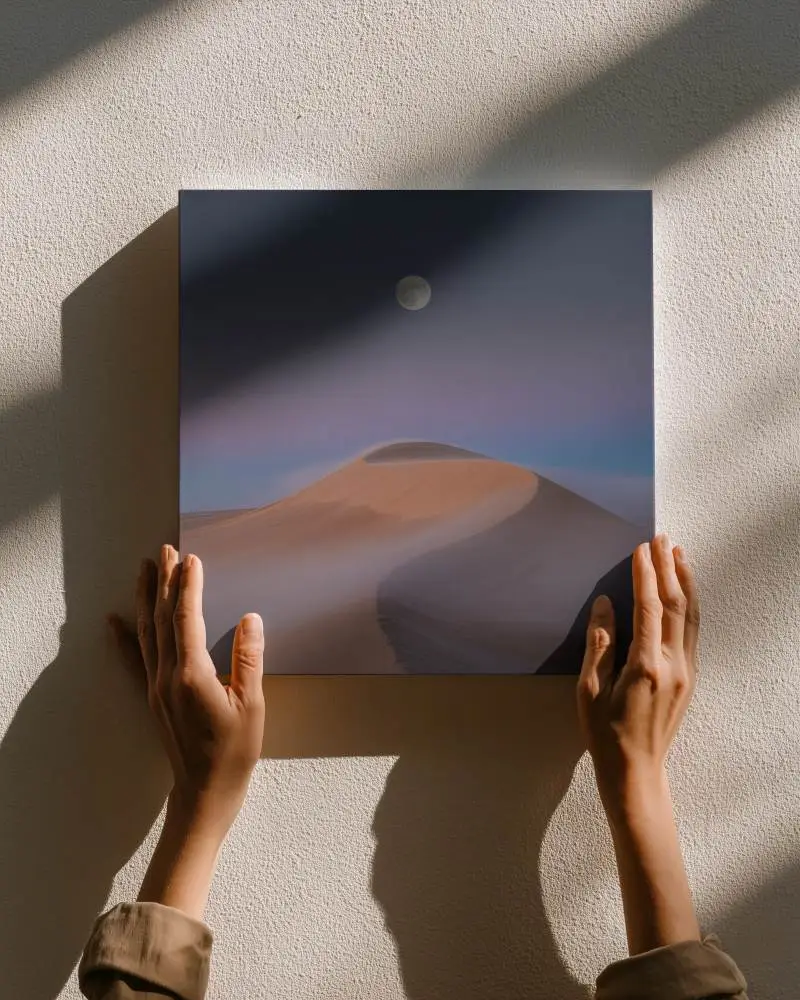 Blank Square Canvas Mockup Being Held On Textured Wall With Sunlight Ray