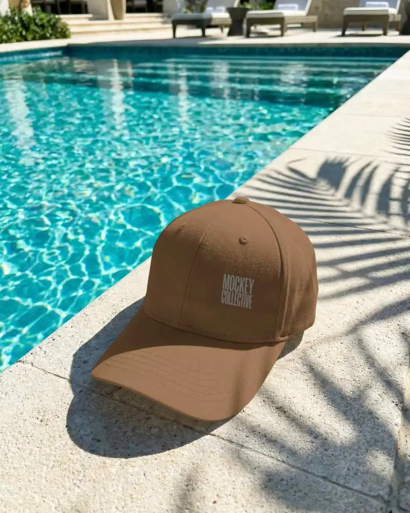 Modern Outdoor Cap Mockup Showcasing Trendy Summer Hat Design By Swimming Poolside Setting