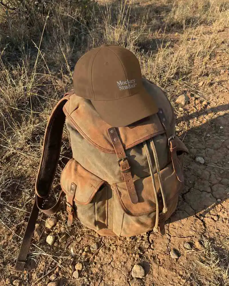 Rugged Hiking Gear Backpack And Baseball Cap Mockup In Wilderness Camping Setup