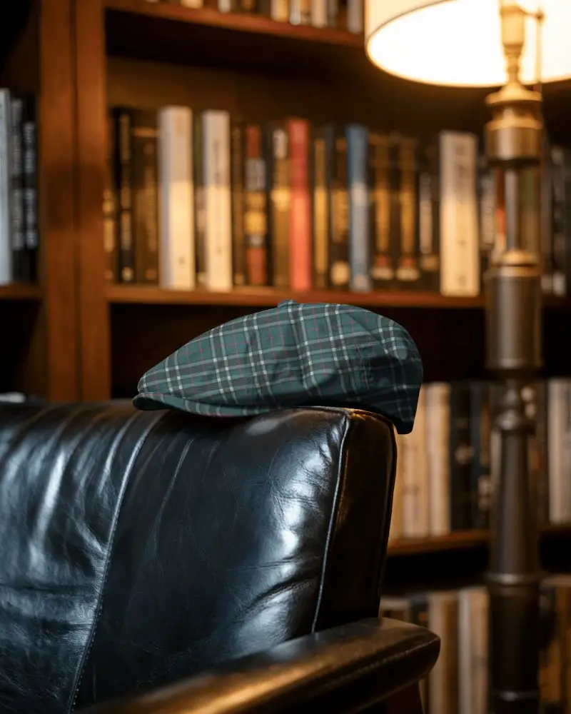 Vintage Library Flat Cap Mockup Resting On Leather Chair Against Bookshelf Under Warm Reading Light
