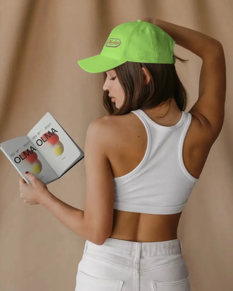 Trendy Sports Cap And Hand Holding Book Mockup Showing Back View And Modern Desig