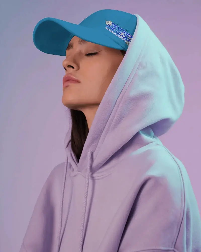 White Cap Mockup On Relaxed Female Model Wearing Purple Hoodie Serene Expression Soft Pastel Background