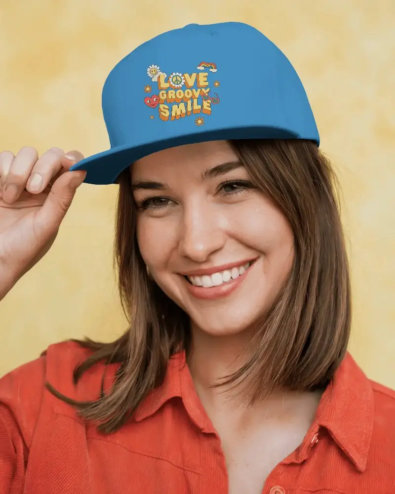 Stylish White Snapback Cap Mockup Featuring Your Design On Front Worn By Smiling Woman In Casual Red Shirt Against Yellow Background