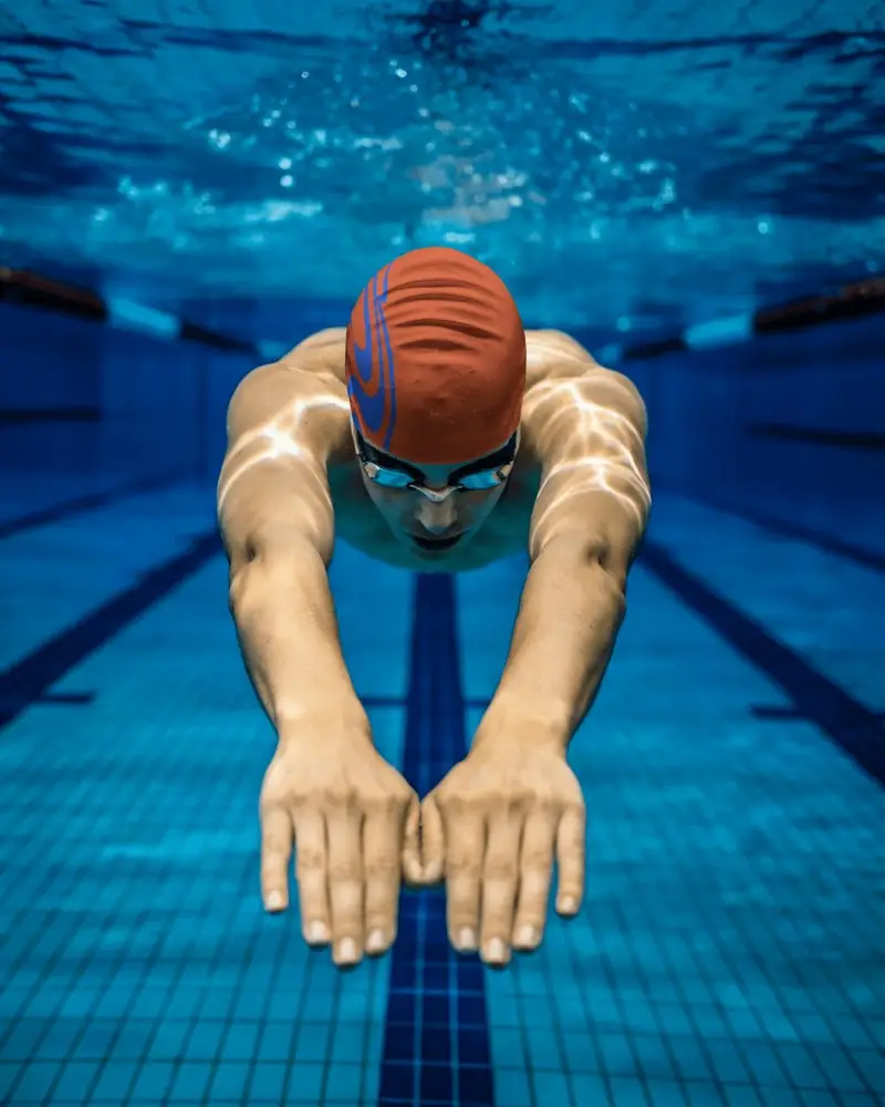 Swim Cap Mockup Featuring Professional Swimmer In Pool Depth Blue Tones And Focus Lighting
