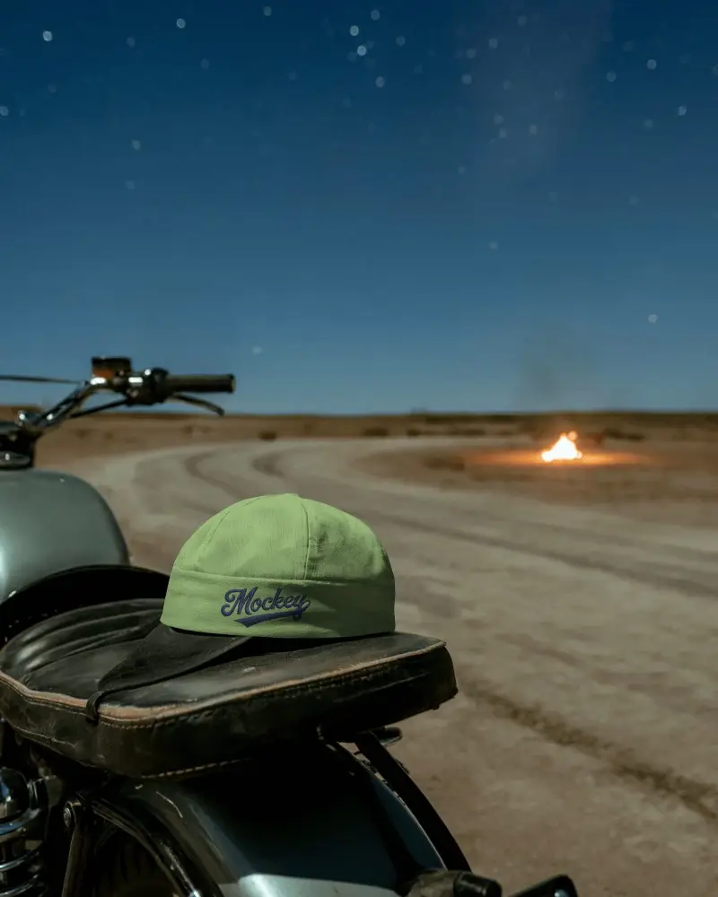 Night Ride Cap Mockup Resting On Motorcycle Seat Under Starry Sky