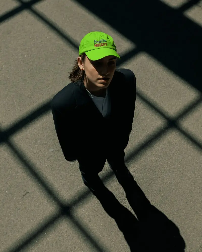 Styled Sleek Cap Mockup On Model With Urban Shadows And Textured Minimal Setting