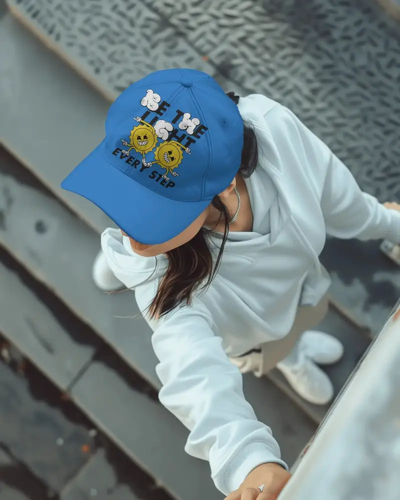 Cap mockup for street fashion brands, overhead view of woman gripping rail, textured steps and minimalist vibe for energetic branding