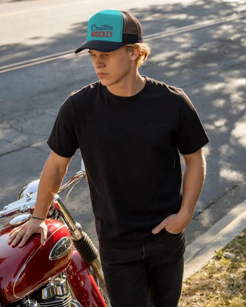 Sunset Street Trucker Hat Mockup Young Man In Dark Outfit Wearing Cap Near Motorcycle On Roadside