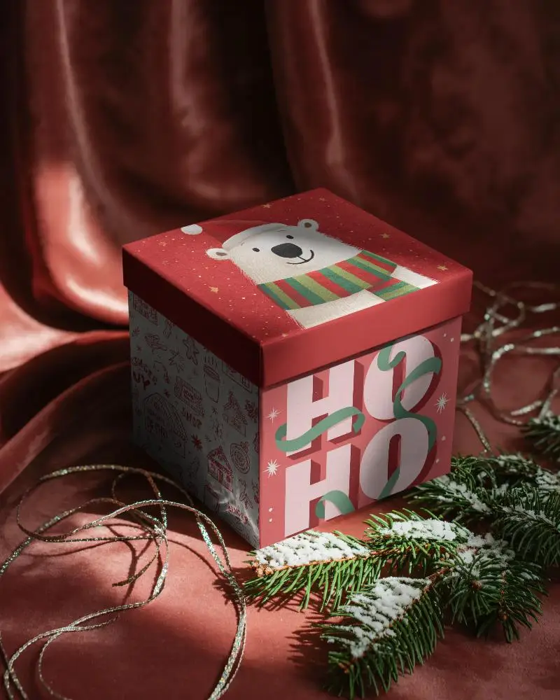 Seasonal Gift Packaging Mockup On Textured Fabric Background With Winter Greenery