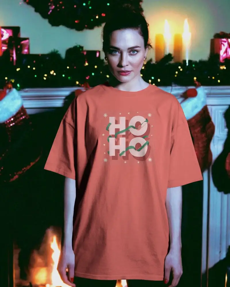 Cozy Christmas Mockup Tshirt Model Standing In Front Of Fireplace With Holiday Decorations