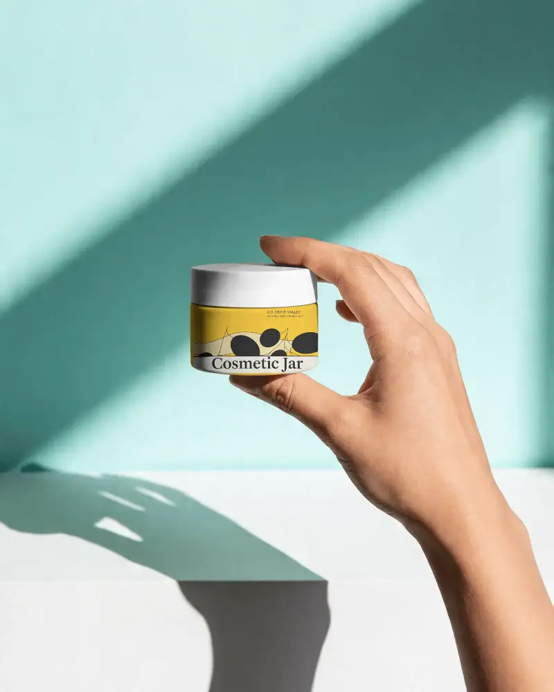 Natural Skincare Cosmetic Jar Mockup Held In Hand With Cast Shadow On Textured Background