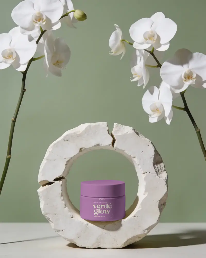Elegant Cosmetic Jar Mockup Displayed In Textured Ring Backdrop With Delicate Blooms